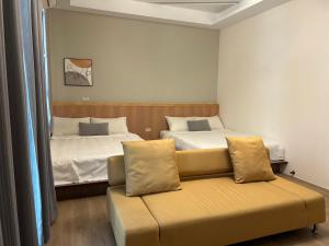 a living room with two beds and a couch at Shower & Sleep in Huxi