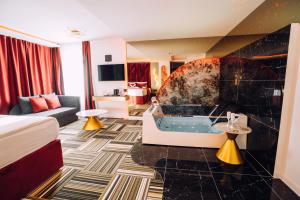 a hotel room with a tub in a room at PARK INN, Bugojno in Bugojno