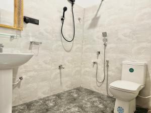 a bathroom with a shower and a toilet and a sink at Crystal Pearl Villa, Weligama - 3min to beach in Weligama