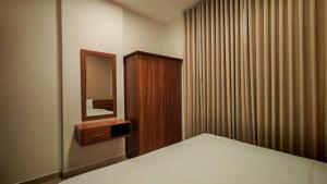 a bedroom with a bed and a dresser and a mirror at Al Khaleej Plaza Furnished Hotel Apartments in Ajman  +22 photos