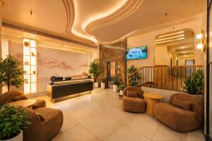 a lobby with a piano and chairs in a building at The Yuvraj By LIVIQ in New Delhi