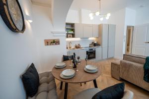 a living room with a table and a couch at Charming coastal escape in Eastbourne +10 photos