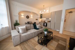 a living room with a couch and a table at Charming coastal escape in Eastbourne