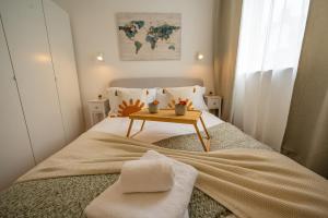 a small bedroom with a bed with a table on it at Charming coastal escape in Eastbourne