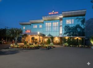 a building with a lot of flowers in front of it at Hotel Asia Vaishnodevi Katra in Katra +8 photos