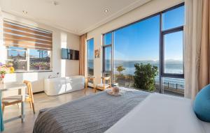 a bedroom with a large bed with a view of the ocean at Blue Sea Hotel in Dali