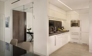 a white kitchen with white cabinets and a counter at The Ritz-Carlton, Herzliya in Herzliya