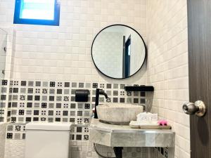 a bathroom with a sink and a mirror on the wall at Phra Ae Apartments in Ko Lanta +48 photos