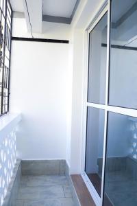 a glass door in a room with a window at Raels home in Mombasa