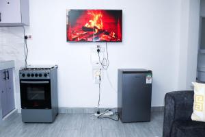 a living room with a stove and a fire at Raels home in Mombasa