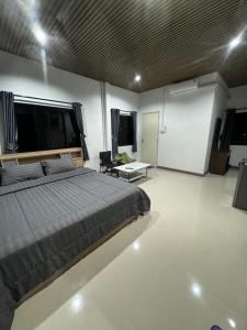 a bedroom with a bed and a living room at บ้านไร่สกายดาวเขาใหญ่ in Ban Nong Khung