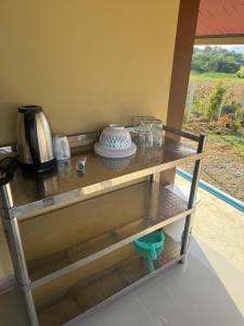 a glass shelf with a vase on top of it at บ้านไร่สกายดาวเขาใหญ่ in Ban Nong Khung