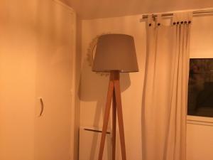 a lamp in the corner of a room with a window at Cosy corner in La Celle-sous-Gouzon