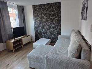 a living room with a couch and a tv at MeerZeit in Emden