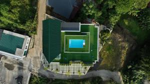 an overhead view of a green building with a swimming pool at Munnar Peak Paradise in Devikolam