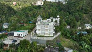 an aerial view of a house on a hill at Munnar Peak Paradise in Devikolam +112 photos
