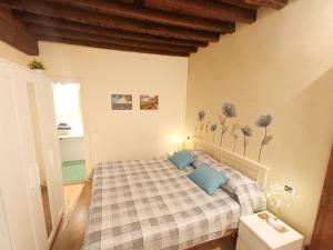 a bedroom with a bed with blue pillows at Il giardino segreto in Lucca