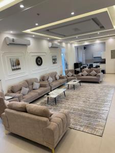 a large living room with couches and a rug at Rimal Chalet in Barka