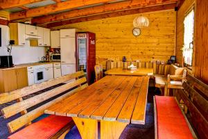 Ferienwohnung Messner-Schauer في سانكت كانزيان: غرفة طعام مع طاولة خشبية ومطبخ