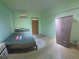 a bedroom with a bed and a dresser and a closet at 103 Lovely AC apartment with private kitchen in Bangkok