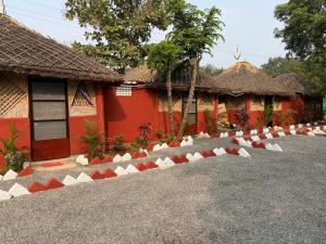 a row of red and white stones in front of a building at SS Aadhya Retreat in Payikāpuram