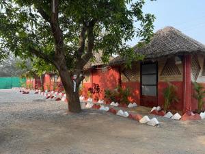 a red building with a tree in front of it at SS Aadhya Retreat in Payikāpuram