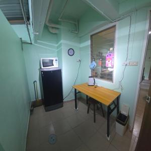 a small room with a table and a microwave at 103 Lovely AC apartment with private kitchen in Bangkok