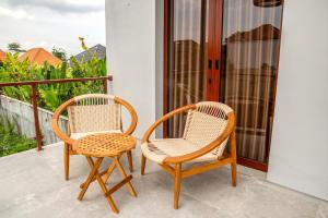 two chairs sitting on a balcony at Rumah Melissa - Modern Boho 3BR Brand New Villa in Sanur in Sanur