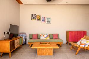 a living room with a couch and a table at Rumah Melissa - Modern Boho 3BR Brand New Villa in Sanur in Sanur