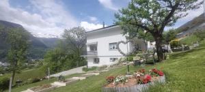 a house on a hill with flowers in a garden at Ferienwohnung Stützen in Brig