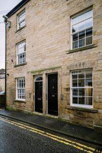 a wooden building with two doors on a street at Sun Street Retreats in Lancaster
