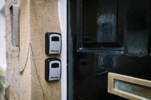 a black door with a cord attached to a wall at Sun Street Retreats in Lancaster