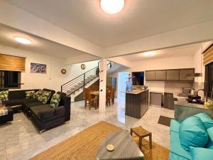 a living room with a couch and a kitchen at Salmaan Villa in Grand-Baie
