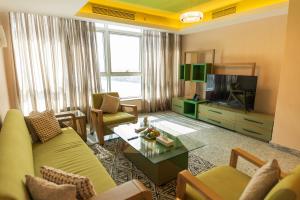 a living room with a couch and a tv at Nile Suites Plaza Hotel Apartments in Cairo
