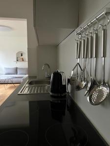 a kitchen with a sink and utensils on a counter at Gemütliche Ferienwohnung in Hüttblek in Hüttblek