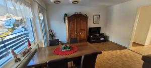 a living room with a table with a red flower on it at Ferienwohnung Stützen in Brig