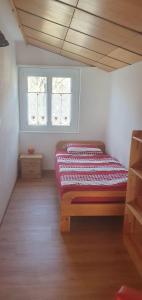 a bedroom with a bed and two windows at Ferienwohnung Stützen in Brig