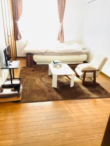 een woonkamer met een bank en een salontafel bij れのん in Okazaki