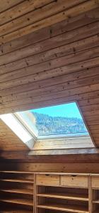 a window in a wooden room with a roof at le flocon chaud in La Bresse