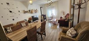 a living room with a table and chairs at Casa Rural Ramblizo in Elche de la Sierra