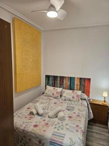 a bedroom with a bed with two hats on it at Casa Rural Ramblizo in Elche de la Sierra