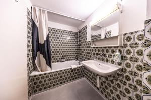 a bathroom with a sink and a mirror at The R Apartment Hemmental in Schaffhausen +26 photos
