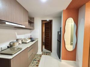 a small kitchen with a sink and a mirror at NM 1BR Condo with Balcony at Horizons 101 in Cebu City