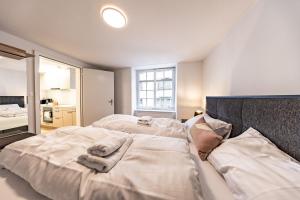 a bedroom with two beds with towels on them at The R Apartment Randen in Schaffhausen