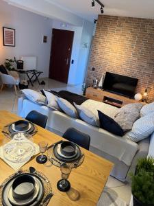 a living room with a couch and tables and a television at addview 2 in Nafplio