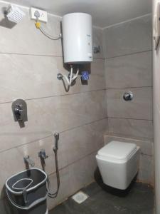 a bathroom with a toilet and a water tank at HOTEL RAJPATH Inn in Mahesāna