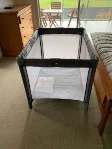 a bed frame with a white mattress in a room at Large Five Bdrm Home Near Beach in Apollo Bay