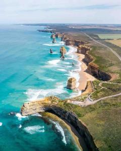 an aerial view of the great ocean road and the twelve apostles at Large Five Bdrm Home Near Beach in Apollo Bay