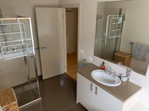 a bathroom with a sink and a shower at Large Five Bdrm Home Near Beach in Apollo Bay +20 photos