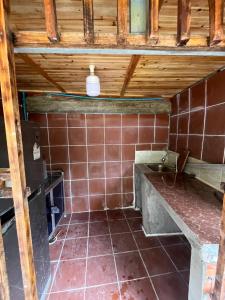 a kitchen with a sink and a tiled floor at Private home in Kampot